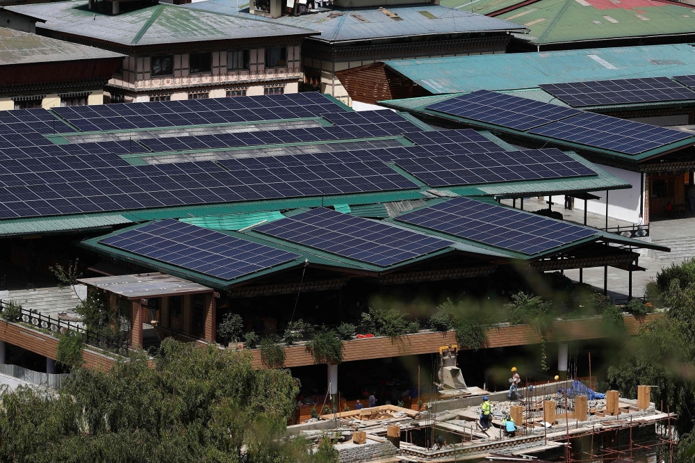 This photograph taken on August 30, 2026, shows solar panels on rooftops of buildings in Bhutan's capital city of Thimphu. (Photo by Niharika Kulkarni / AFP)
