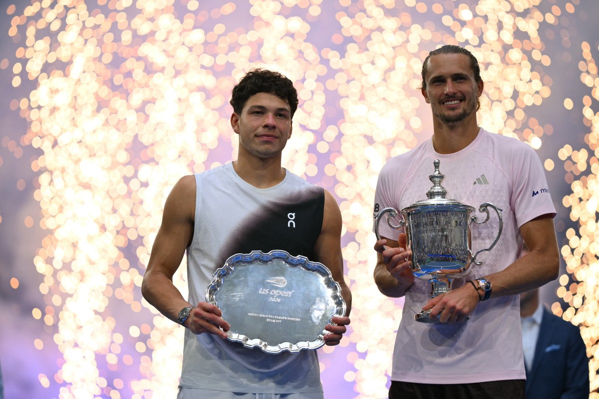 USA's Ben Shelton holds the runner-up trophy next to Germany's Alexander Zverev who holds the winner's trophy after the men's singles final tennis match of the US Open tennis tournament on September 13, 2026. (Photo by Angela Weiss / AFP)
