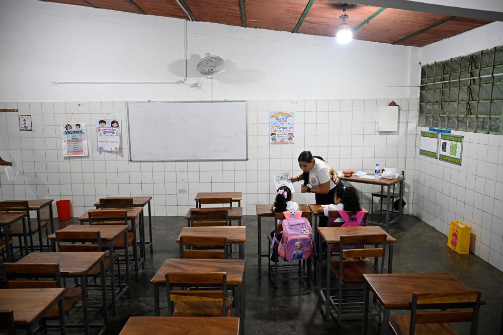 A teacher talks to her students during a class at the beginning of the school year in La Guaira, Venezuela on September 15, 2026.  (Photo by Federico PARRA / AFP)