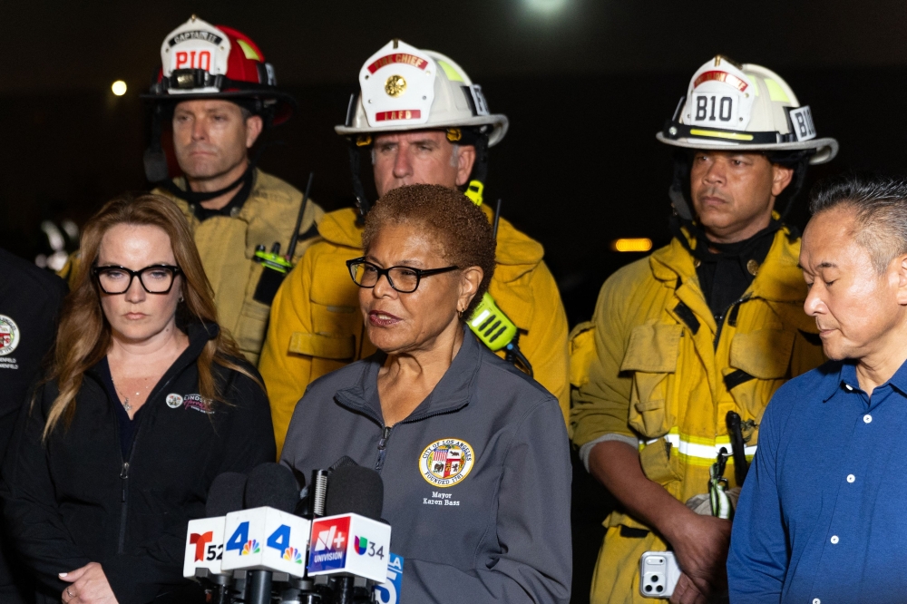 Los Angeles Mayor Karen Bass (C) briefs reporters after a US news media helicopter covering a deadly bus crash, came down in Chatsworth, a neighborhood of Los Angeles, California on September 15, 2026. (Photo by Blake Fagan / AFP)