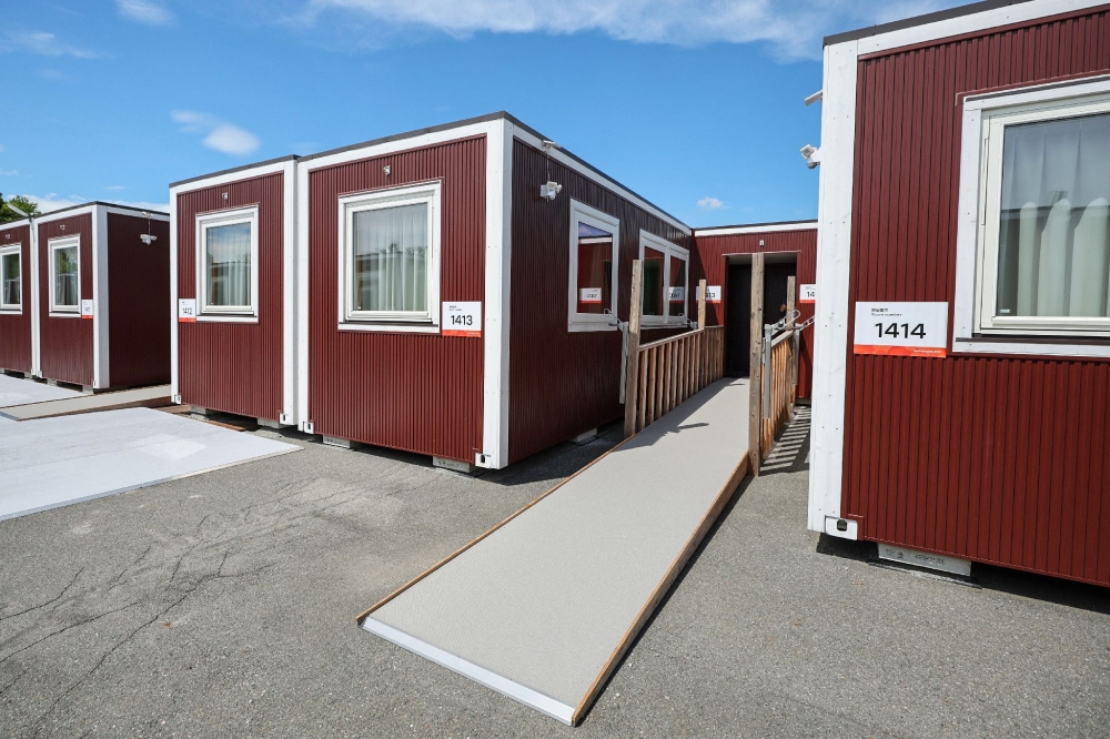 This picture taken on August 26, 2026 and released on September 18, 2026, shows temporary container huts being used to house athletes for the 2026 Asian Games at the Garden Pier in Nagoya. (Photo by JIJI Press / AFP) 