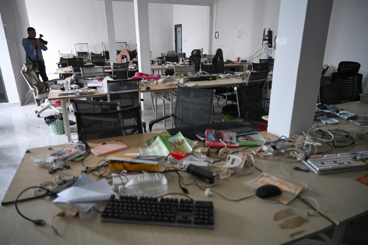 A journalist takes pictures of abandoned equipment at a closed cyber scam centre in Bavet town, Svay Reang province on September 21, 2026. (Photo by TANG CHHIN SOTHY / AFP)