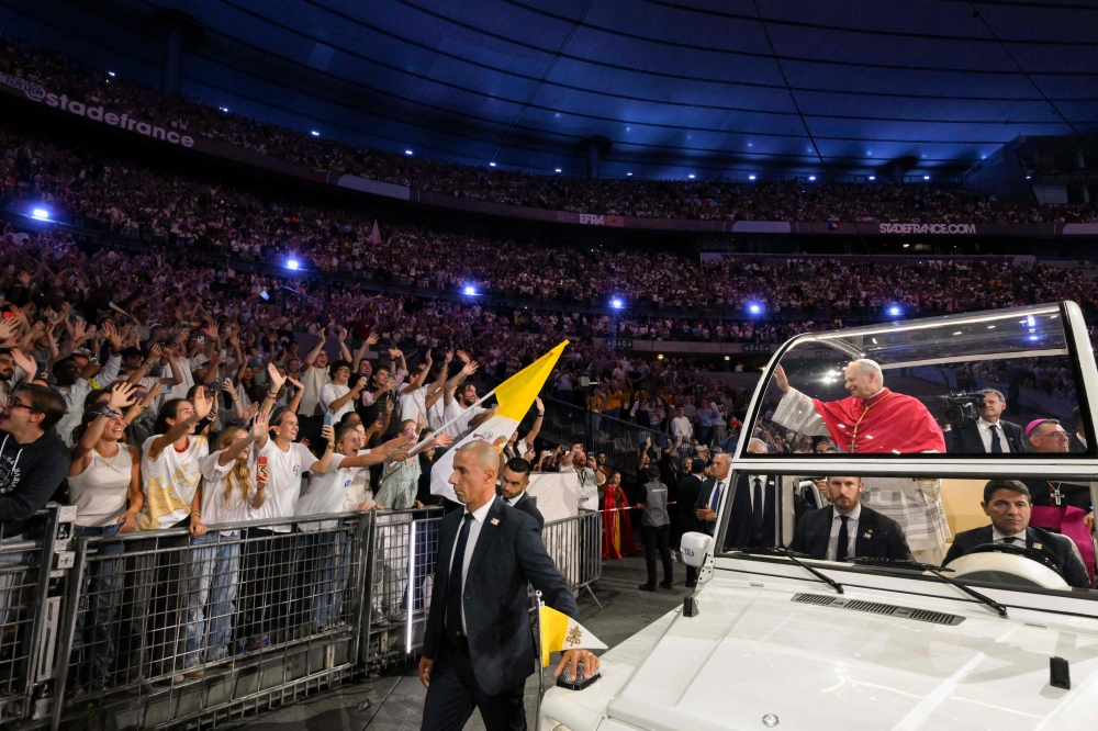 This photo taken on September 25, 2026, by The Vatican Media shows Pope Leo XIV greeting worshippers from the Popemobile car. (Photo by Simone Risoluti / Vatican Media / AFP)