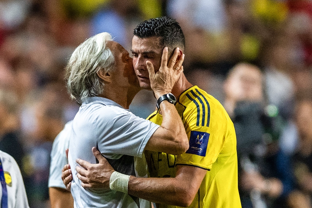 (Files) Al-Nassr's head coach Jorge Jesus (L) embraces Cristiano Ronaldo during the Saudi Super Cup semi-final football match on August 19, 2025. (Photo by Wun Suen / AFP)