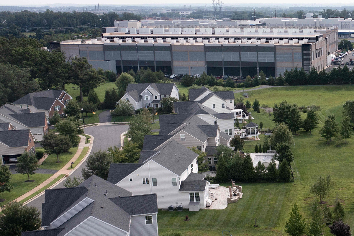 This aerial view shows an Amazon Web Services (AWS) data center adjacent to single-family homes in Stone Ridge, Virginia on August 12, 2026. Photo by Brendan Smialowski / AFP
