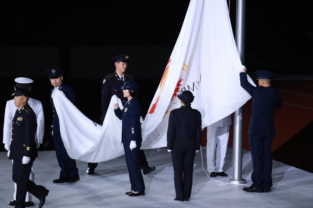 Members of the Japan Self-Defense Forces lower the Olympic Council of Asia (OCA) flag during the closing ceremony of the 2026 Asian Games at Nagoya City Mizuho Park Athletic Stadium in Nagoya, Aichi Prefecture on October 4, 2026. (Photo by David Gray / AFP)