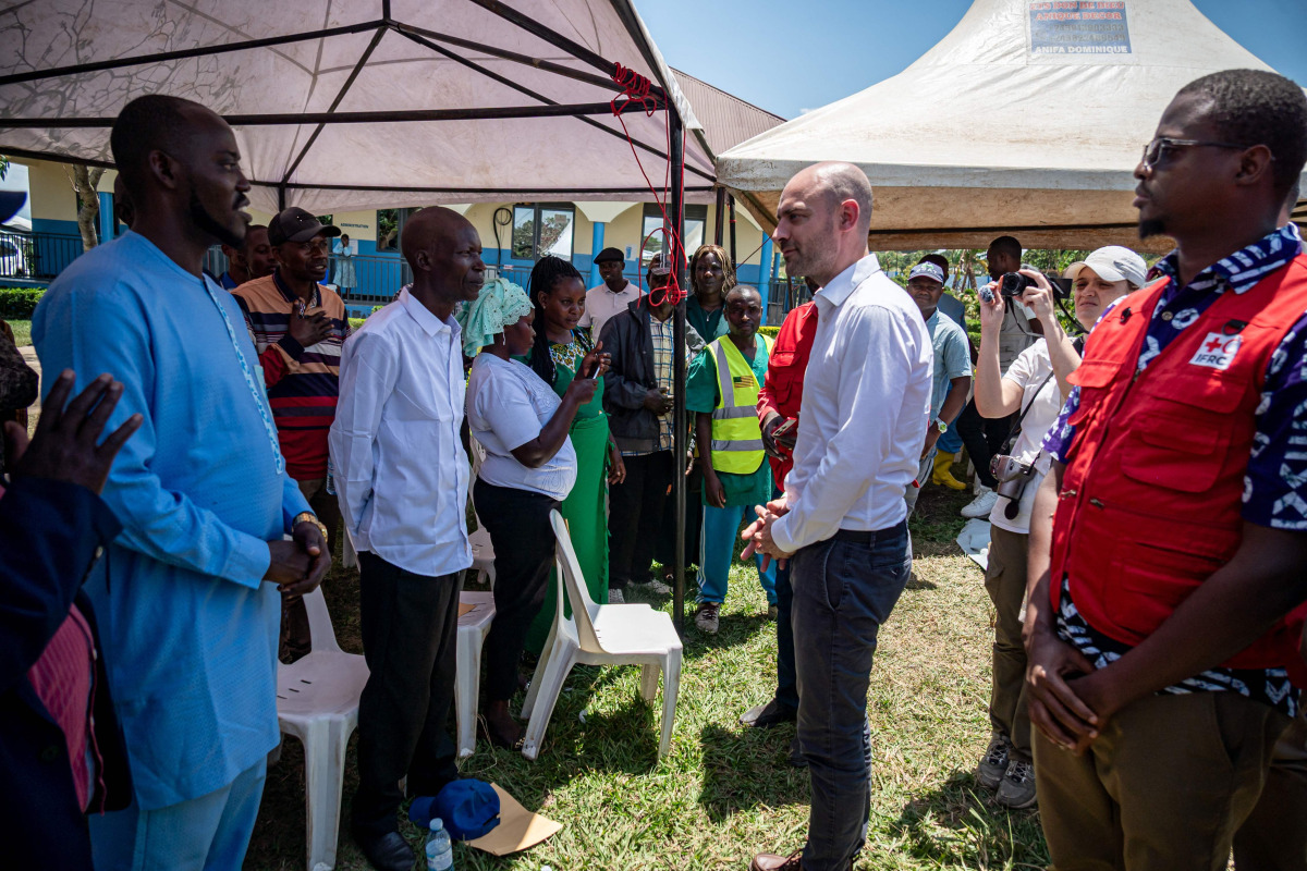 French Minister for Europe and Foreign Affairs Jean-Noël Barrot speaks with family members of Ebola patients during his visit to the Rwampara Ebola Treatment Centre in Bunia, Ituri Province, Democratic Republic of Congo, on October 3, 2026. (Photo by Hardy BOPE / AFP)