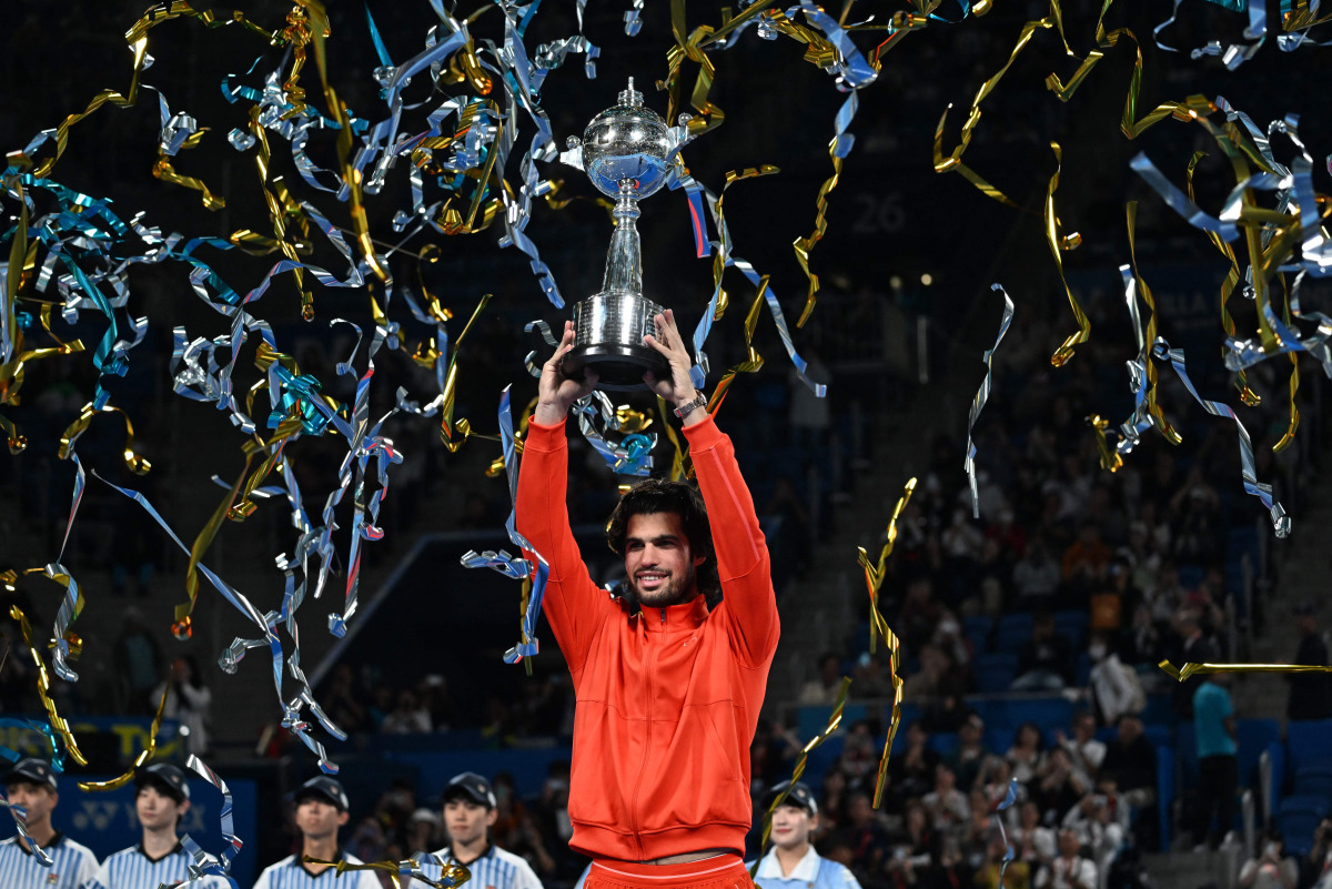 Spain's Carlos Alcaraz holds the trophy as he celebrates beating Czech Republic's Jiri Lehecka in the men's singles final during the Japan Open tennis tournament at the Ariake Tennis Forest Park in Tokyo on October 6, 2026. (Photo by Rie KIKUCHI / AFP)