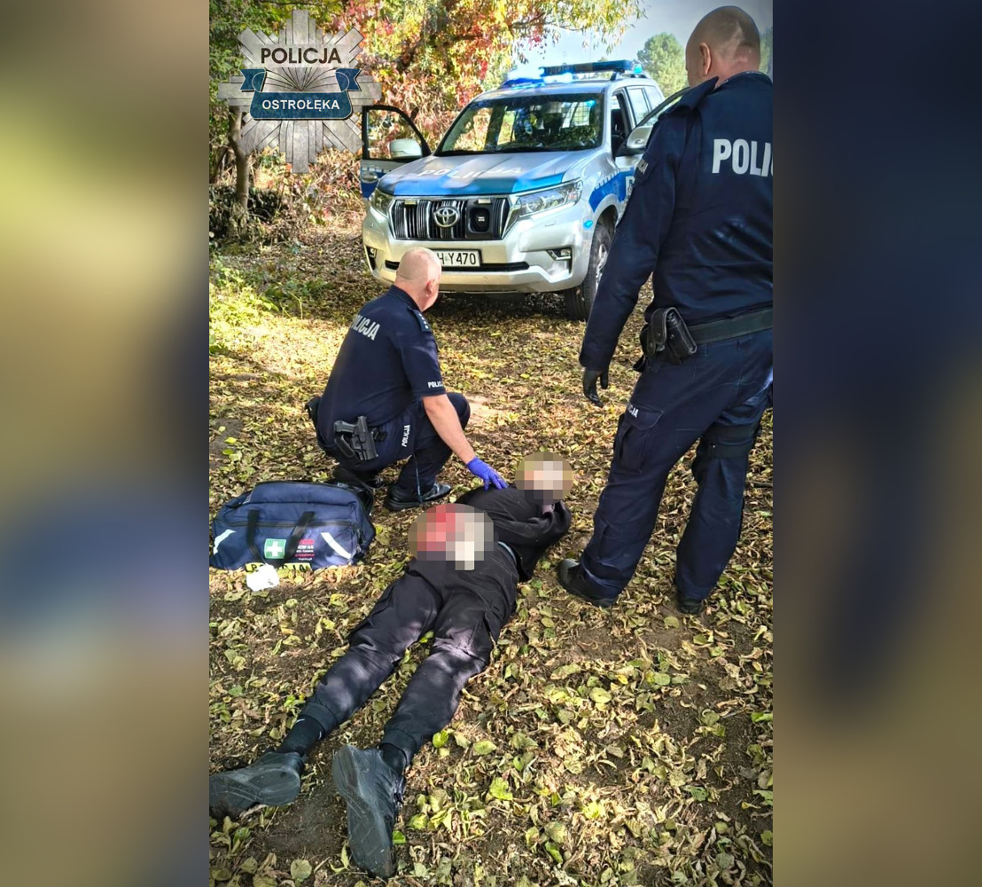 This handout picture taken and released by Policja Mazowsze on October 7, 2026, shows two policemen detaining a suspected high school knife attacker in the town of Ostroleka, some 130 km north of Warsaw. Photo by Handout / Policja Mazowsze / AFP
