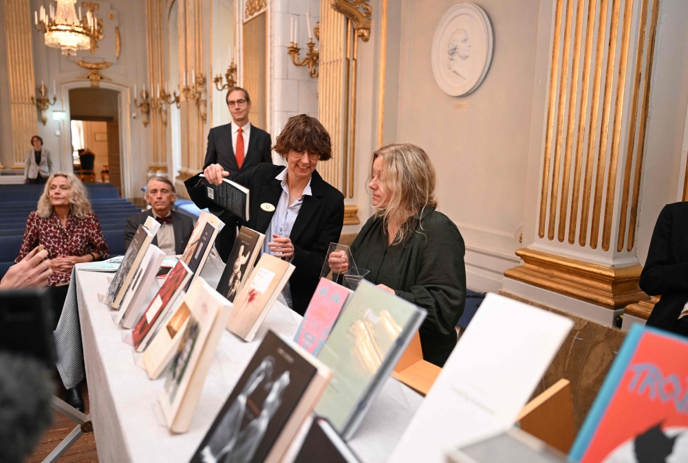 Copies of books by Canadian author Anne Carson are on display at the Swedish Academy in Stockholm, Sweden, after a press conference on October 8, 2026 to announce her as the winner of the 2026 Nobel Prize in Literature. (Photo by Jonathan Nackstrand / AFP)