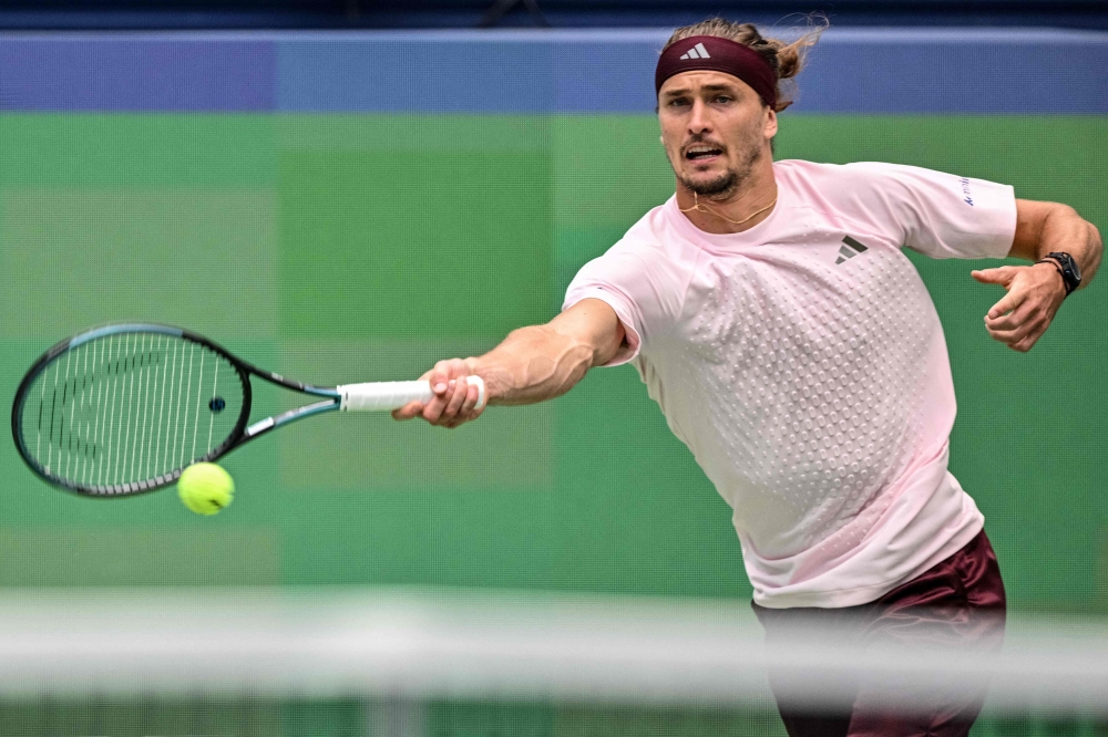 Germany's Alexander Zverev hits a return to China's Wu Yibing during their men's singles match at the Shanghai Masters tennis tournament in Shanghai on October 9, 2026. (Photo by Hector RETAMAL / AFP)