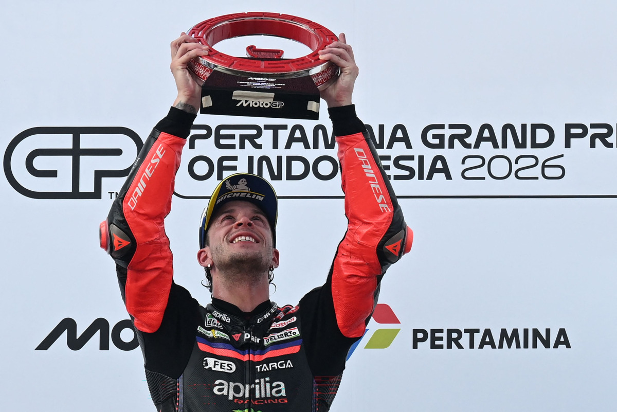Aprilia Racing Italian rider Marco Bezzecchi celebrates on the podium after winning the MotoGP Indonesian Grand Prix at the Mandalika International Circuit in Mandalika on October 11, 2026. (Photo by SONNY TUMBELAKA / AFP)