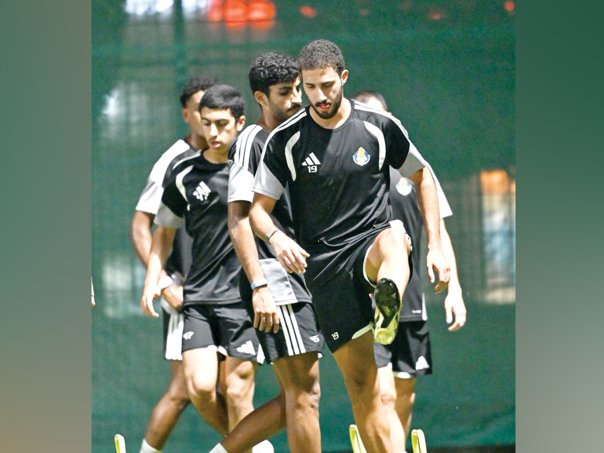Al Gharafa players in action during a training session.