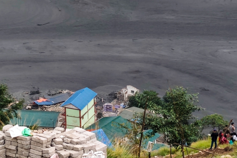 People look at damage to a hydropower plant complex under construction along the Budhi Gandaki river in Nepal's Gorkha district on October 11, 2026. (Photo by Sovit Shrestha / AFP)