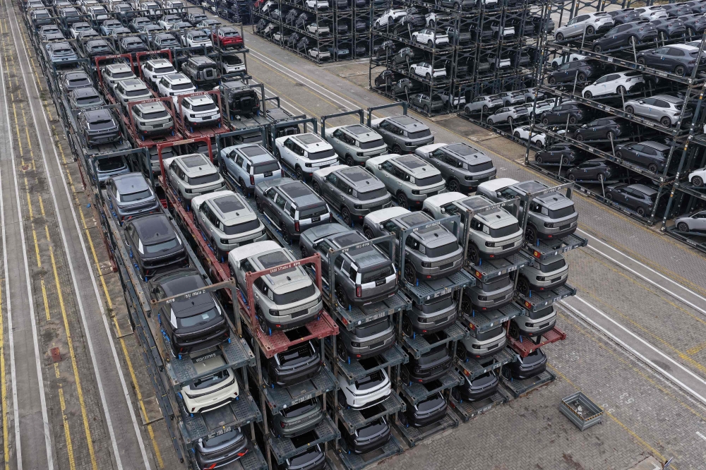 Chinese-made cars are seen in specialised vehicle racks in preparation for loading onto ships for export at the Taicang Port area of Suzhou Port on October 12, 2026. (Photo by CN-STR / AFP) 