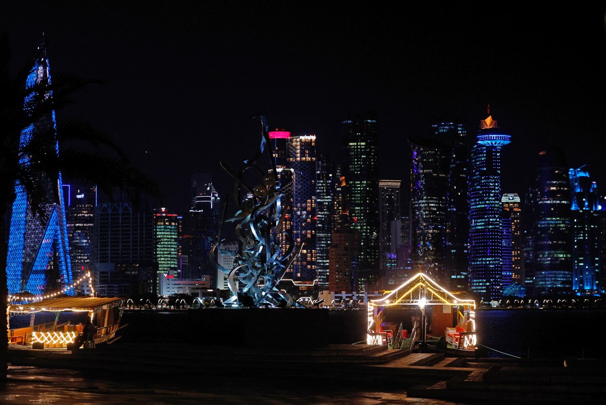 The Corniche promenade facing the skyline of illuminated high-rise buildings is pictured in Doha on October 11, 2026. (Photo by KARIM JAAFAR / AFP)
