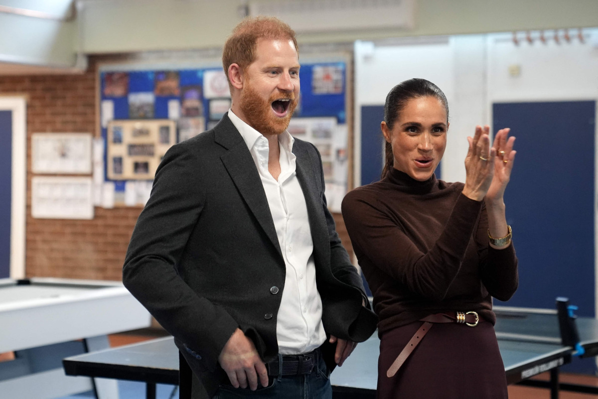 Britain's Prince Harry, Duke of Sussex and his wife Meghan, Duchess of Sussex, react during a visit to Epic Partners in Nottingham, central England on October 15, 2026. Photo by Joe Giddens / POOL / AFP