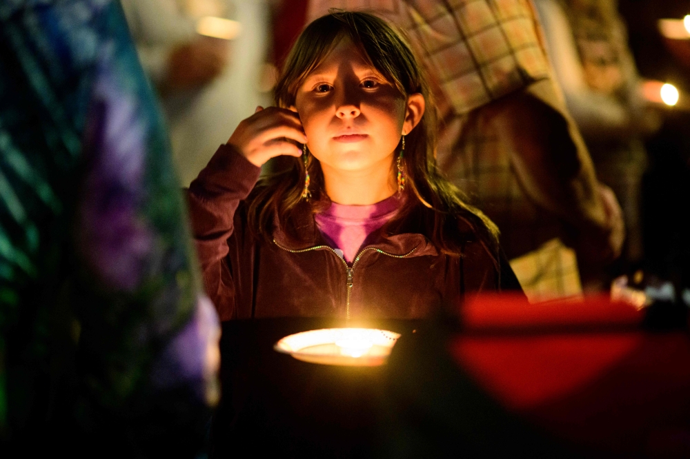 Community members grieve during a candlelight vigil at Peace Corner on October 16, 2026 in Bend, Oregon. Mathieu Lewis-Rolland/Getty Images/AFP