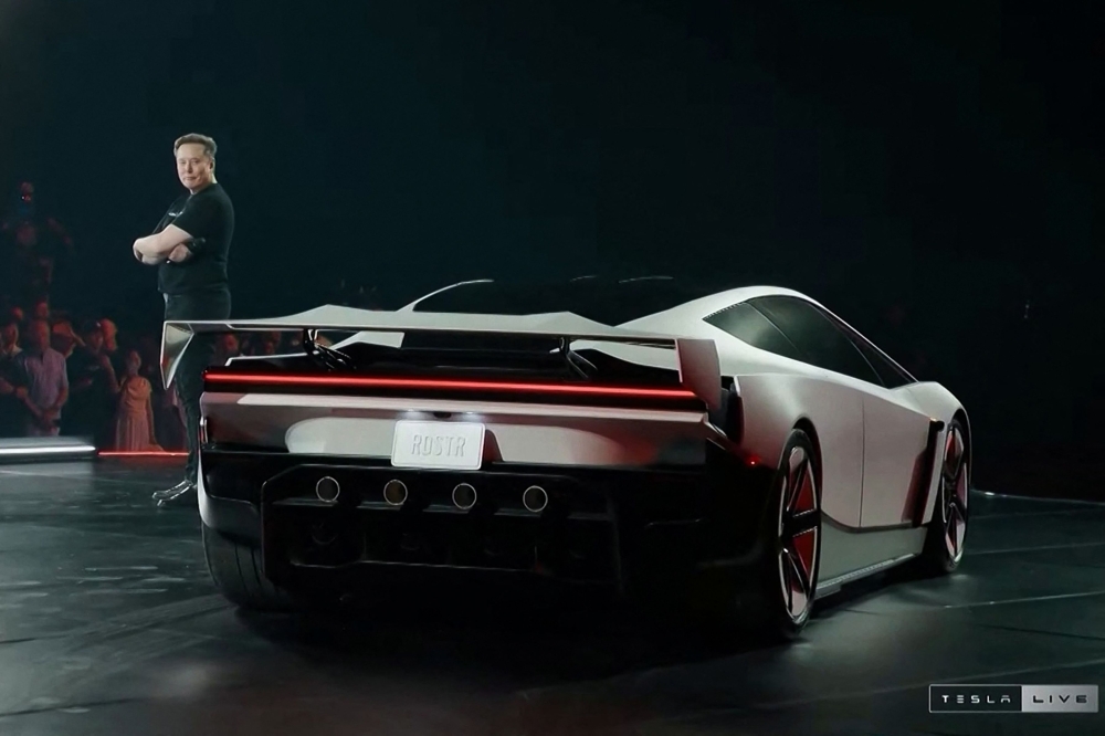 A grab taken on October 16, 2026 from a live feed released by Tesla shows Tech billionaire Elon Musk unveiling on October 15 the next-generation Roadster electric car in McGregor, Texas, United States. (Photo by Tesla / AFP)