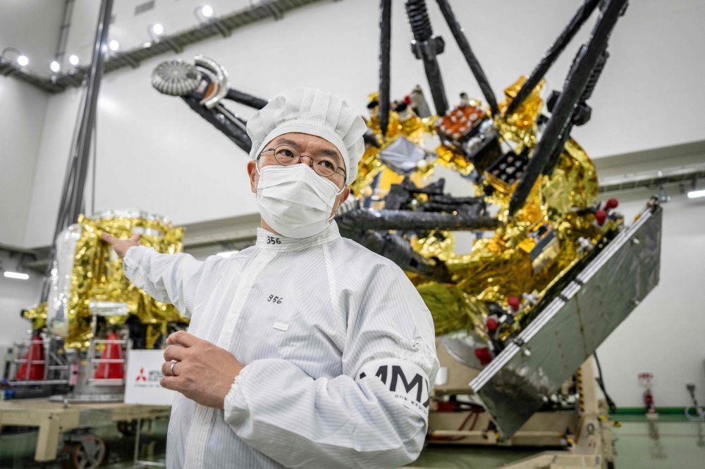 (FILES) Yasuhiro Kawakatsu, project manager of the Mars Moons eXploration (MMX) mission, speaks to media in front of the MMX spacecraft at the Tanegashima Space Center in Minamitane, Kagoshima prefecture on August 13, 2026. (Photo by Yuichi YAMAZAKI / AFP) 