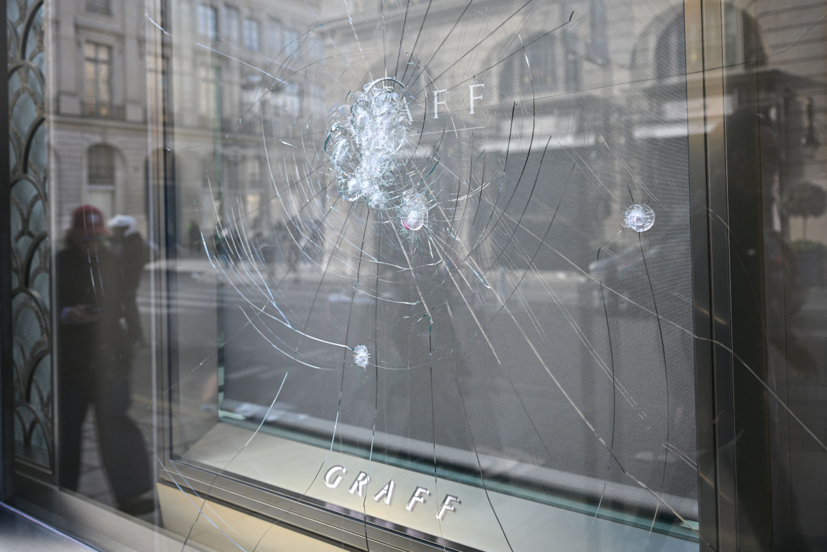 This photograph shows the damaged shop windows of the jeweller 