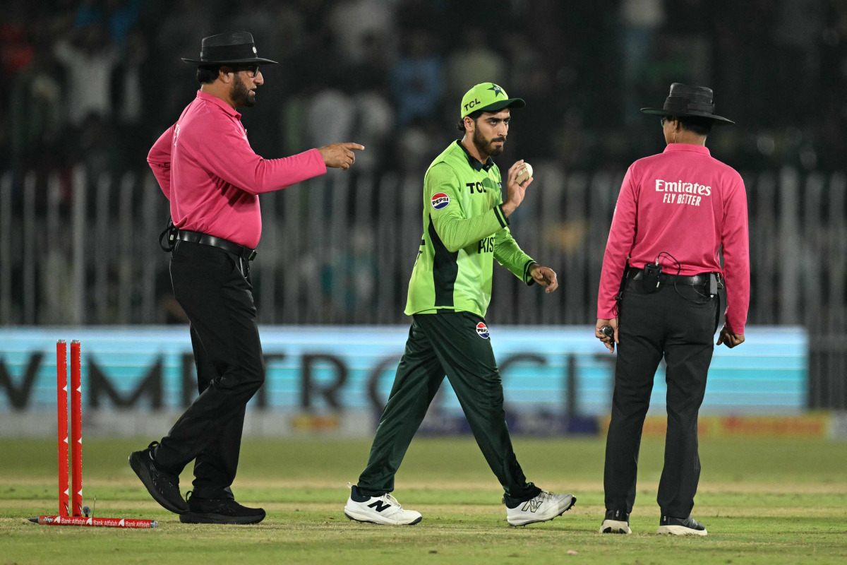 Pakistan's Arafat Minhas (C) celebrates after taking his sixth wicket to dismiss England's Adil Rashid as umpires Pakistan's Faisal Afridi (L) and Bangladesh's Sharfuddoula react during the one-day international (ODI) tri-series cricket match between Pakistan and England at the Rawalpindi Cricket Stadium in Rawalpindi on October 20, 2026. (Photo by Aamir QURESHI / AFP)