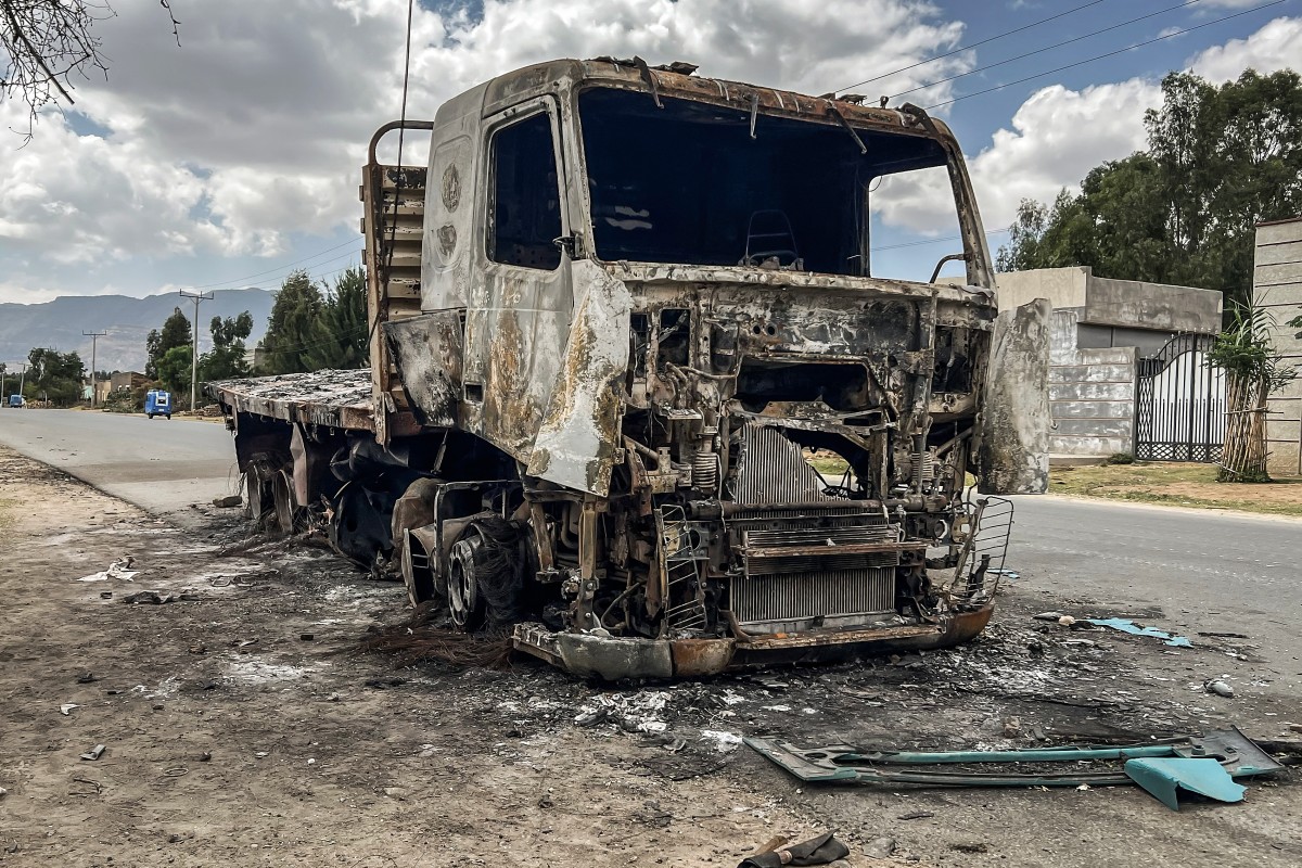 A truck belonging to the Tigray People's Liberation Front (TPLF) stands burned along a road following clashes between Ethiopian federal forces and armed groups opposed to the government in Adigrat on October 17, 2026. (AFP)
