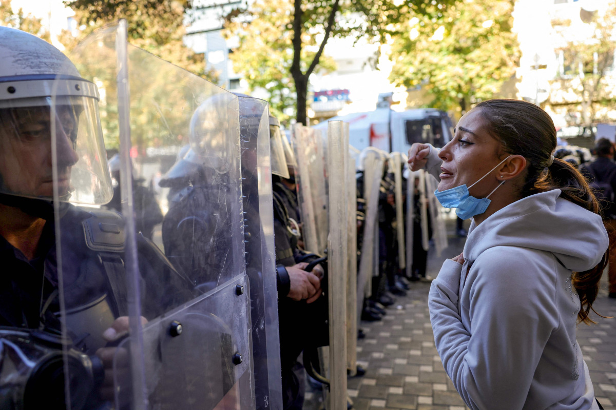 A protester faces riot police officers during an anti-government demonstration in central Tirana on October 20, 2026, after a week of violent anti-government protests. Photo by Adnan Beci / AFP