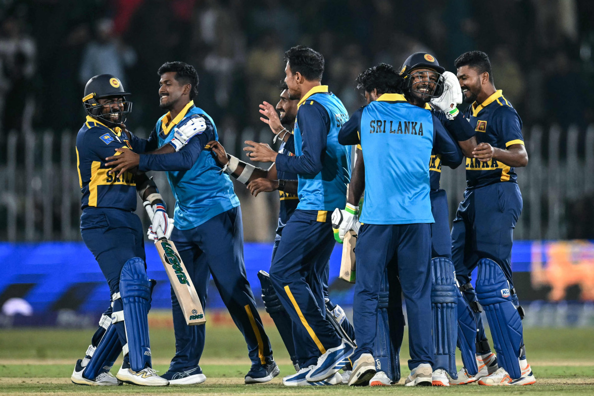 Sri Lanka's players celebrate after their victory in the one-day international (ODI) tri-series cricket match between England and Sri Lanka at the Rawalpindi Cricket Stadium in Rawalpindi on October 22, 2026. (Photo by FAROOQ NAEEM / AFP)