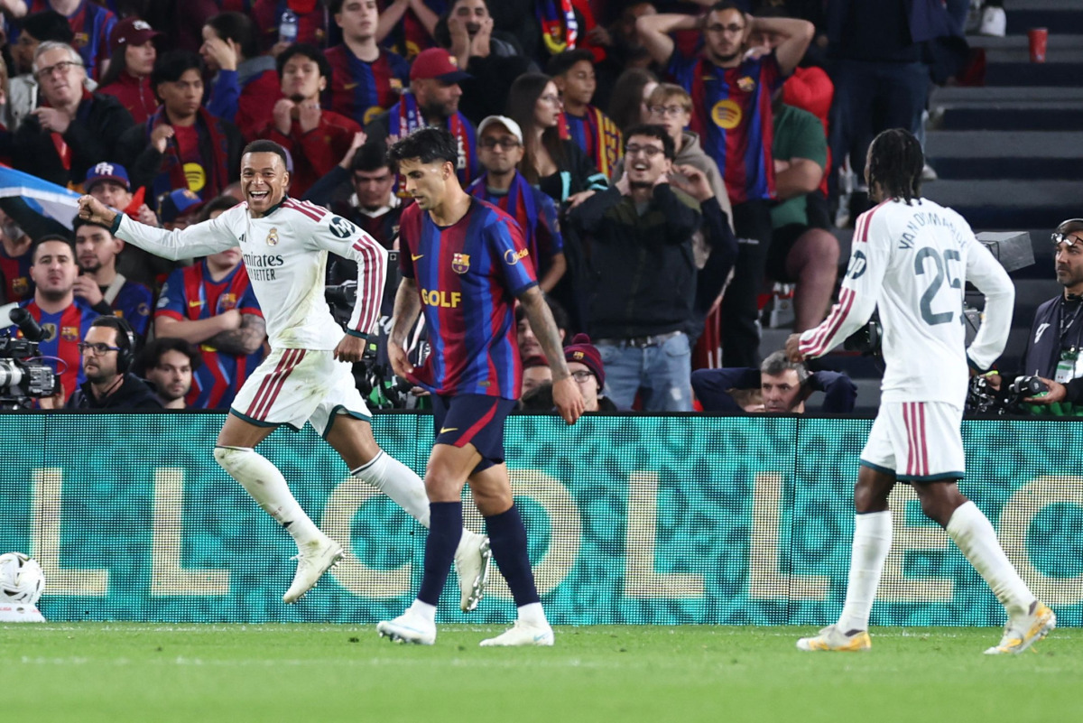Real Madrid's French forward #10 Kylian Mbappe (L) celebrates scoring his team's first goal during the Spanish league football match between FC Barcelona and Real Madrid CF at Camp Nou Stadium in Barcelona on October 25, 2026. (Photo by Josep LAGO / AFP)