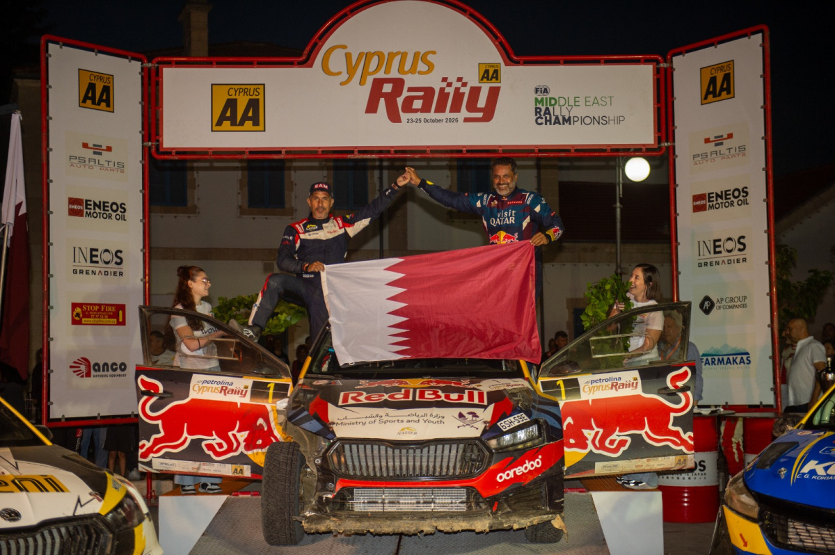 Qatar's Nasser Al-Attiyah and his Spanish navigator Candido Carrera celebrate their victory.  