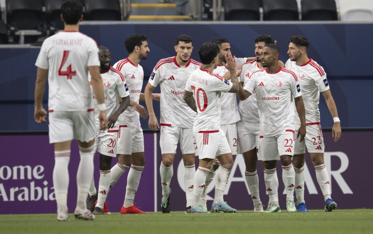 Al Shamal players celebrate a goal against Al Hilal.