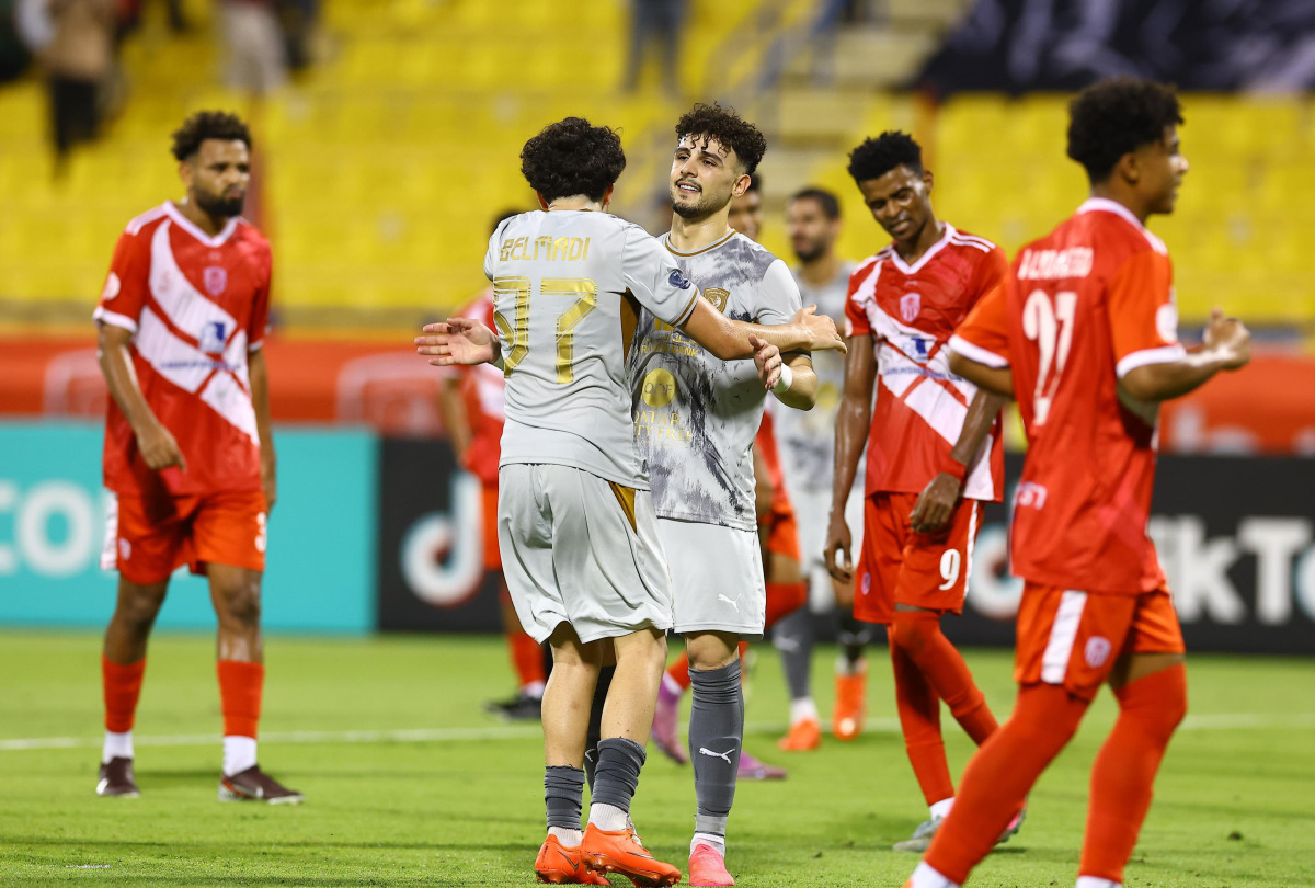 Al Duhail’s Bassam Al-Rawi (centre) celebrates after converting a stoppage-time penalty.   