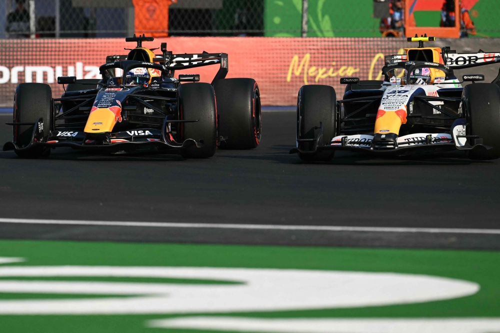Red Bull Racing's Dutch driver Max Verstappen (L) and Racing Bulls' New Zealand driver Liam Lawson race in Mexico City on October 30, 2026. (Photo by Yuri Cortez / AFP)